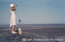 pgm0183 Maria Reiche using Contax camera on pampa in 1950s